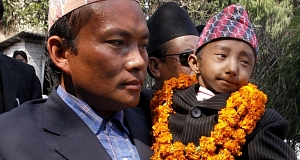 Khagendra Thapa Magar, 18, being carried by his father Rup Bahadur Thapa Magar. Khagendra Thapa Magar, 18, being carried by his father Rup Bahadur Thapa Magar.